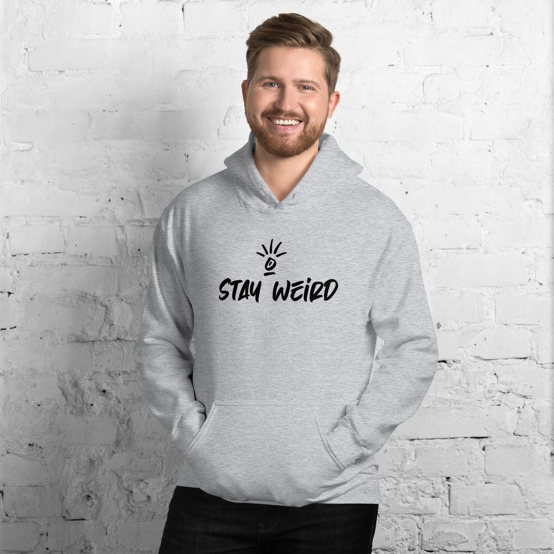 Comfortable 'Stay Weird' unisex hoodie, modeled to display its snug fit and the bold declaration of personal pride and comfort.